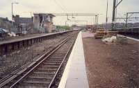 Looking east at Airdrie station. 303 in bay platform and electrification train in sidings.<br><br>[Ewan Crawford //1987]