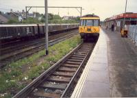 Looking west at Airdrie station. Electrification train in sidings. These are mostly lifted now.<br><br>[Ewan Crawford //1987]