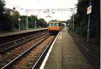 Looking east at Cartsdyke station. Class 303 in station.<br><br>[Ewan Crawford //]