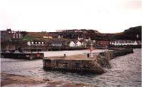 View looking south over Cullen harbour, former line of railway and its viaducts behind town.<br><br>[Ewan Crawford //]