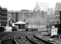 26034 on the 1248 Edinburgh - Perth pulling away from the Haymarket stop in April 1980. The trainshed to the left of the locomotive is part of the original Edinburgh & Glasgow Railway terminus and was removed 2 years later when the remains of the old coal yard (far left) were cleared to make way for a car park. It now forms part of the SRPS station at Boness.<br><br>[John Furnevel 18/04/1980]