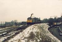 Class 47 with flatbed train and crane lifting track at Trinity during the lifting of the line between Granton and Powderhall. View looks east.<br><br>[Alan Bain //]