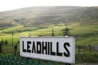 Looking west from Leadhills station over the station signboard.<br><br>[Ewan Crawford 15/08/2004]