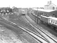 The old station and shed at Carstairs in August 1975 looking south east from the road bridge. The train about to pull into a busy platform 2 will be picking up passengers recently arrived off a connecting service from Edinburgh Waverley. <br><br>[John Furnevel 24/08/1975]
