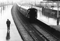 Where is he going in this weather? Glasgow Central - Stranraer train arrives at Ayr in a thunderstorm in the spring of 1972.<br><br>[John Furnevel 02/03/1972]