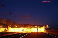 The brightly lit station looking south. The clock tower and covered walkway to the pier can be seen on the right.<br><br>[Ewan Crawford 4/6/2004]