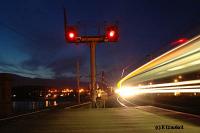 Looking north as a train enters from Glasgow. The lights of Wemyss Bay are reflected in the Firth of Clyde to the left.<br><br>[Ewan Crawford 4/6/2004]