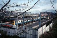 Class 303 sits in Milngavie station on a sunny winter day.<br><br>[Ewan Crawford //]