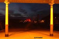 Looking north from the end of the canopies over platforms 1 and 2. The Inverkip Power Station chimney can be seen in the distance; two vertically spaced red lights in the right centre of the view.<br><br>[Ewan Crawford 4/6/2004]