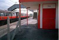 Looking east at Paisley St James with the station building and a Glasgow bound train.<br><br>[Ewan Crawford //]