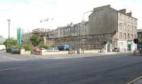The Great Wall of Leith. The north wall of Leith Central station in 2006, now forming the boundary of the Co-op Supermarket car park. View northwest across Easter Road, with part of the western abutment of the railway bridge that once spanned the road still standing. The grey roof of the Co-op supermarket is visible on the extreme left of the picture, while just out of shot alongside is 'Leith Waterworld', a leisure facility which was also built on the site of the old station. [See image 11664]  <br><br>[John Furnevel 22/07/2006]