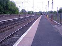 A Class 318 about to pass through Lochwinnoch Station with a fast train to Glasgow.<br><br>[Graham Morgan 14/06/2006]