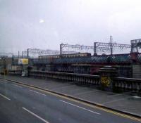 A Class 156 departs Glasgow Central across the Clyde Viaduct. The supports for the old viaduct are in the forground. Taken from Glasgow Bridge.<br><br>[Graham Morgan 17/06/2006]