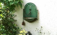 Interesting ornamental plant container attached to the wall of a house near the former Pomathorn station, Penicuik, in August 2006.<br><br>[John Furnevel 06/08/2006]