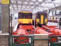 Modified Class 318 318257 and Class 156 156512 stand at Platform 6 & 7 waiting their turn to depart.<br><br>[Graham Morgan 05/08/2006]
