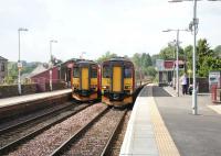 Trains from Glasgow Central and Kilmarnock pass at Barrhead in August 2006. View south.<br><br>[John Furnevel 17/08/2006]