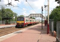 Looking along platform 1 at Coatdyke station in August 2006 as a train for Airdrie departs.<br><br>[John Furnevel /08/2006]