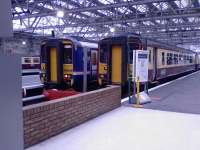 Two class 156s at Glasgow Central, one in SPT colours and one in First corporate colours<br><br>[Graham Morgan 26/08/2006]