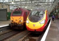 The front of Virgin West Coast Class 390 Pendolino 390046 Virgin Soldiers and EWS Class 67 67019 which is ready to haul away the empty Caledonian Sleeper coaches at Glasgow Central<br><br>[Graham Morgan 26/08/2006]