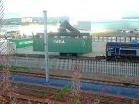 DRS Class 66 66403 at WH Malcolms Elderslie Freight Terminal offloading freight. Here a mobile crane lifts an ISO box from a flat car for transfer to an articulated lorry.<br><br>[Graham Morgan 06/09/2006]