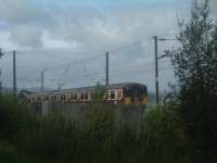 Class 318 318265 passes WH Malcolms Freight Terminal at Elderslie<br><br>[Graham Morgan 06/09/2006]