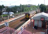 The next train for Glasgow Central draws into the northbound platform at Whifflet after reversal on 24 August 2006.<br><br>[John Furnevel 24/08/2006]
