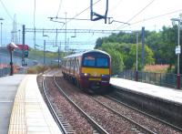Westbound train arriving at Easterhouse in September 2006 formed by 320321.<br><br>[John Furnevel 01/09/2006]