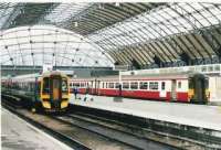 158701 leaves for Edinburgh past a new arrival with unusual colours. The vast glass roof from 1912 is impressive.<br><br>[Brian Forbes //2002]