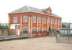 The former station at Granton Gasworks, photographed on 16 August 2006. Built by the Edinburgh & Leith Gas Commissioners in 1902 for the use of headquarters staff and still displaying the appropriate corporate seals on the front of the building. What is now an arched window in the centre of the upper floor originally provided access to an integral footbridge which crossed various lines and sidings to reach the works. The building will be retained as part of the <I>Waterfront Development</I> with various alternative uses currently being considered.<br><br>[John Furnevel 16/08/2006]