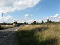 A new bridge is under construction over the Dunfermline-Alloa road.  The line from Kincardine joined the main Stirling-Dunfermline line (which was carried on the embankment on the right) at Kincardine Junction in the centre right of this picture.<br><br>[Mark Poustie 23/09/2006]