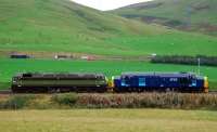 Strange working: 47815/D1748 Great Western and 37515 head south loudly. Almost blottng out the noise of the M74.<br><br>[Ewan Crawford 29/09/2006]
