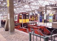 A busy scene at Glasgow Central with a Class 314 and two Class 156s awaiting passengers.<br><br>[Graham Morgan 30/09/2006]