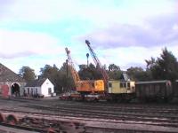 Two multi use cranes. Diesel and steam at Aviemore shed 60B.<BR/>The red car is acting as a scotch, maybe.<br><br>[Brian Forbes 23/09/2006]