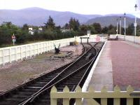 The shunt head where SPR locos run around at Aviemore. Level access to the Strathspey Platform is via a boardwalk protected by the gate, or via the NR station footbridge, for the fitter. The Grampian Mountains in the distance.<br><br>[Brian Forbes 19/09/2006]