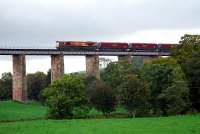An EWS class 66 locomotive with a loaded coal train from Killoch washery ventures out onto Enterkine Viaduct in October 2006.<br><br>[Ewan Crawford 06/10/2006]