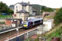 Despite having seen better days the old station at Markinch still retains much character. Scene shows the main station buildings with a train at platform 2 on 20 October 2006 with work getting underway off camera on the revised station layout and new interchange building.<br><br>[John Furnevel 20/10/2006]