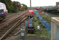 View south from Markinch station on 20 October 2006 with a train about to leave for Edinburgh. The redundant groundframe stands at the former junction for the Leslie branch and local goods yard, lifted track from which stands on the right. <br><br>[John Furnevel 20/10/2006]