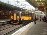 156434 stands at Platform 4 with the Stranraer service while modified 318257 pulls into Platform 3 with a Glasgow Central service<br><br>[Graham Morgan 25/10/2006]