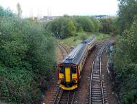 Glasgow bound Sprinter crawls slowly past Cowlairs North Junction to a red signal on the approach to Cowlairs West Junction and the main E&G line into Queen Street.<br><br>[Ewan Crawford 28/10/2006]