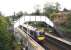 The ever-so-slightly exotic (even in the rain) east end of Polmont station with an Edinburgh service pulling away in September 2006. <br><br>[John Furnevel /09/2006]