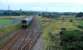 Looking south at Derwent Junction. Workington Docks line to right, Workington station in distance. A train consisting of a two carriage and single carriage Sprinter heads south.<br><br>[Ewan Crawford 27/09/2006]