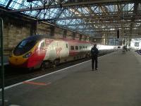 Virgin Pendolino 390029 'City of Stoke-On-Trent' at  Glasgow Central Platform 2 in November 2006. An officer from the British Transport Police is busy carrying out security checks along the platforms <br><br>[Graham Morgan 02/11/2006]