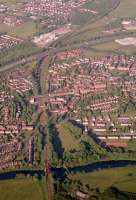 Aerial view of Uddingston looking east showing the viaduct (and former viaduct), station and junction.<br><br>[Ewan Crawford //1988]