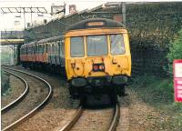 Different liveries obvious as this 311 is coupled to a 303a as it approaches Blairhill. Helensburgh Central is the destination.<br><br>[Brian Forbes //1988]