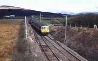 A 303 heads for Dumbarton along the recently singled line from Balloch just north of Dalreoch. The disconnected line is still in place. 15 April 1973.<br><br>[John McIntyre 15/04/1973]