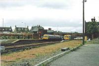 101s pass at Larbert, on the Dunblane/Edinburgh service. The far track is canted for speed.<br><br>[Brian Forbes //1984]