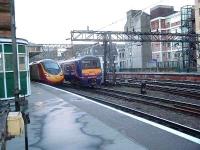 322482 passes 390001 at Glasgow Central. The Class 322 formed the train for the service to North Berwick. <br><br>[Graham Morgan 05/12/2006]
