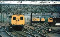 The holding sidings to the east of Guide Bridge station housed electric locomotives for use on trans-pennine freight via Woodhead. A Manchester bound DC electric service passes the sidings early in 1981 on the approach to Guide Bridge station. The Woodhead route was closed later that year.<br><br>[Ian Dinmore //1981]