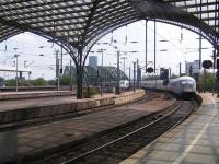 Dutch State Railways ICE-3 arrival from Amsterdam passes InterCity train departing for Hamburg over the 6 track Hohenzollern Bridge over the Rhein in July 2006.<br><br>[Paul D Kerr 24/07/2006]