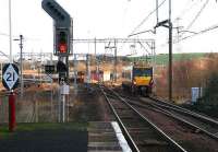 View east from the platform at Newton station on 5 January 2007. On the left is the WCML. In the centre a terminated service waits in the reversing siding at Newton East Junction pending its return to Glasgow. On the right a Milngavie train is approaching the station from Lanark. <br><br>[John Furnevel 05/01/2007]